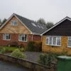 Street side view of bungalow with roof lift