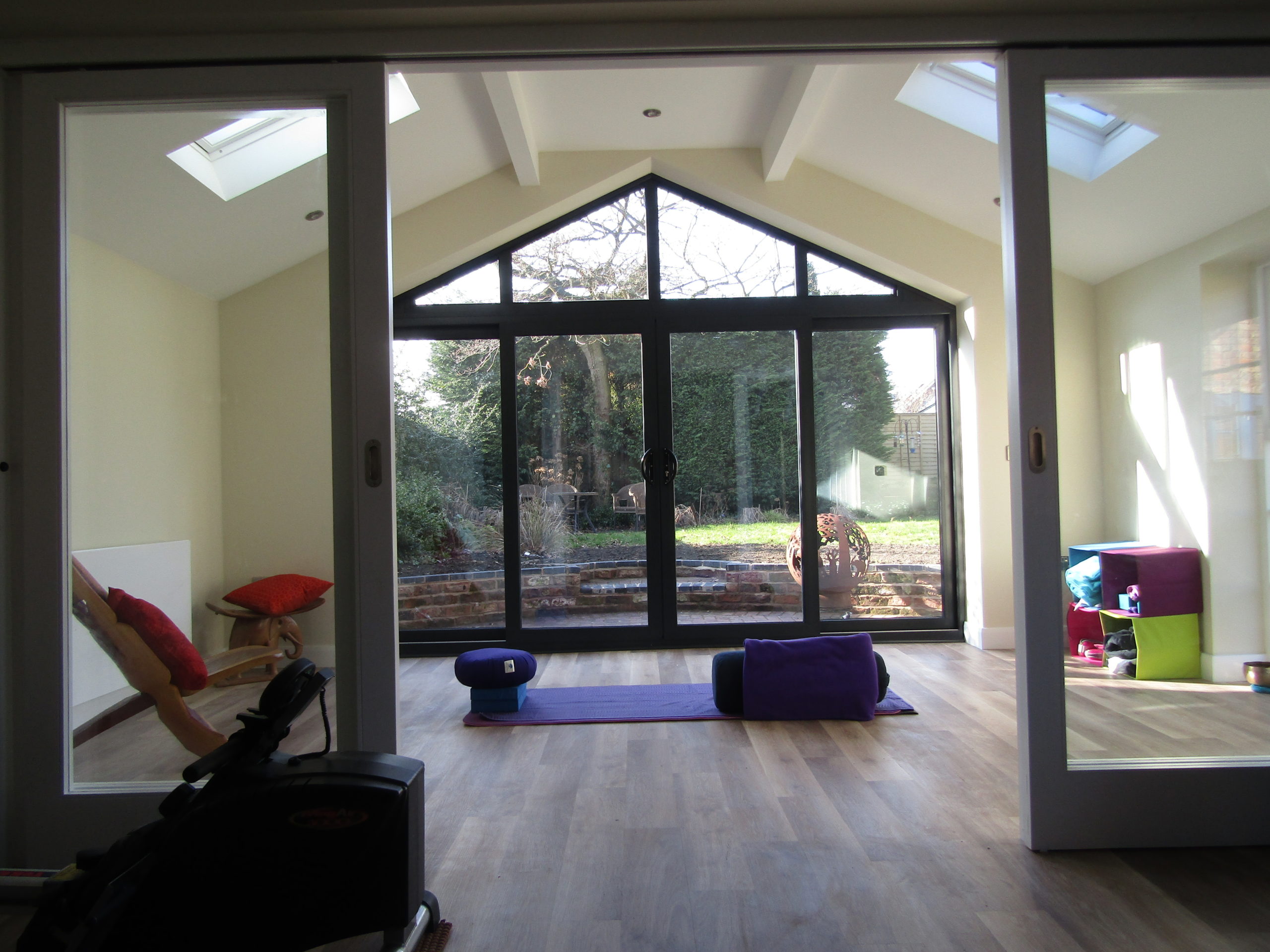 Spacious fitness centred garage conversion room.