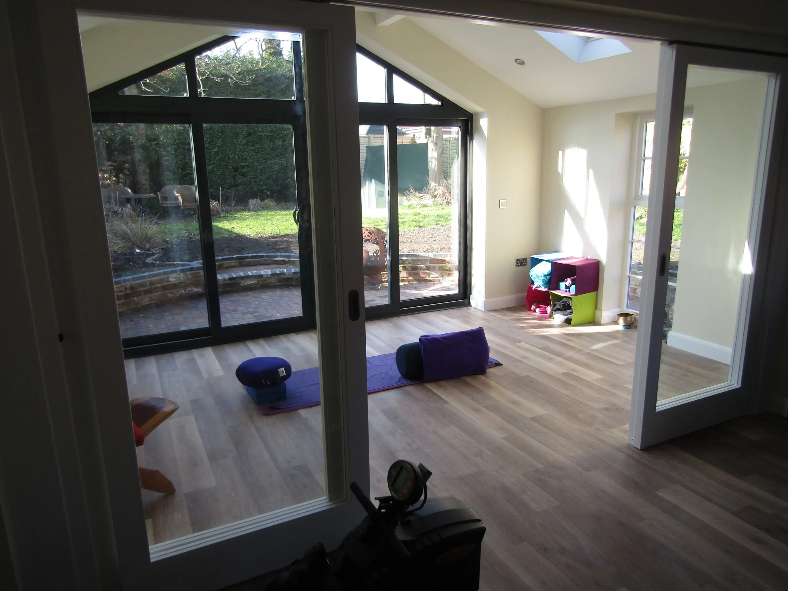 garage gym with skylight and double doors