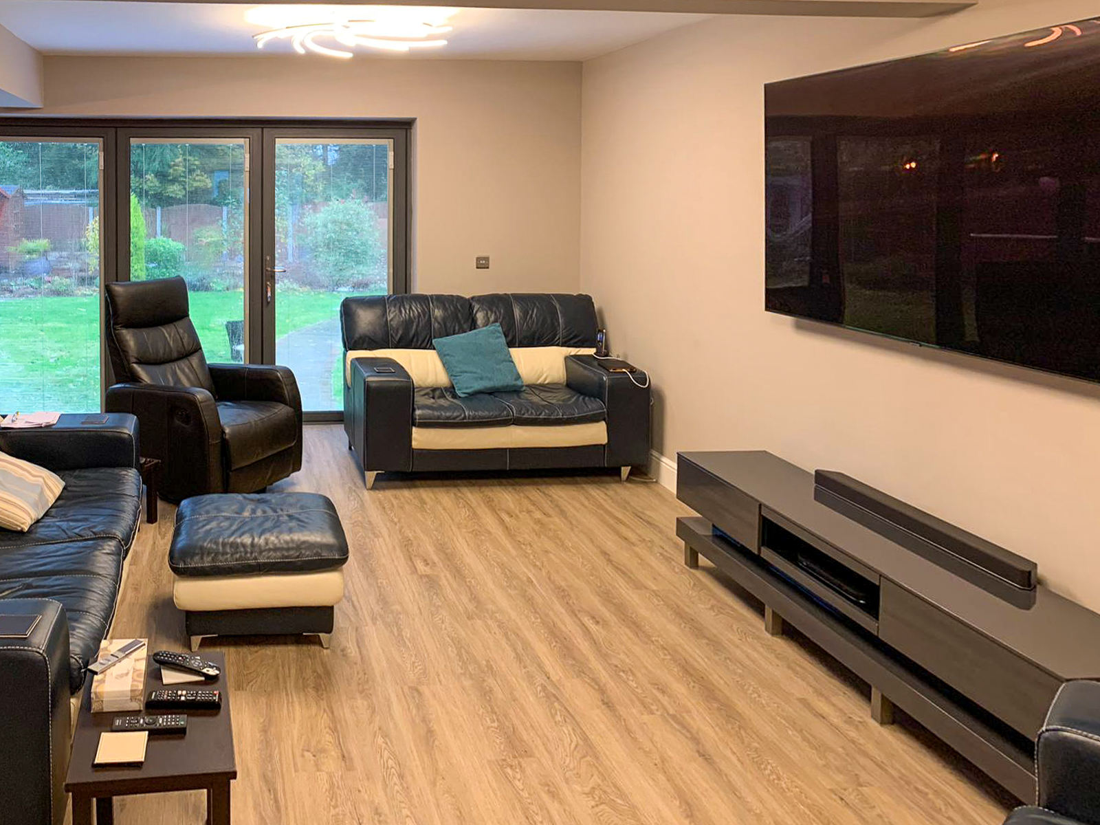 Living and seating area with entertainment system in double storey extension